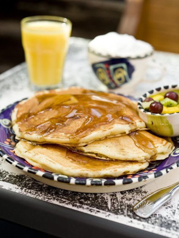 Every morning's a little bit brighter with a stack of pancakes drizzles in pure maple syrup.