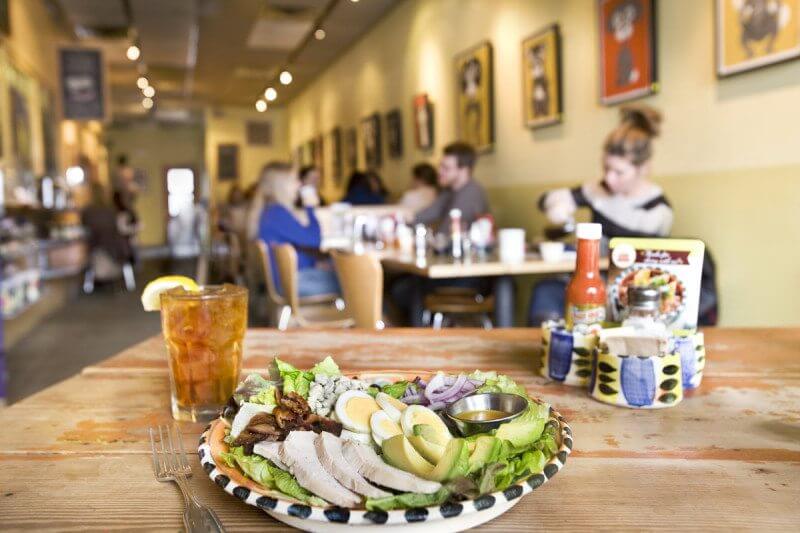 Cozy tables, kitschy decor, and rotating art exhibits all add to the homespun atmosphere at Stone Soup Kitchen.