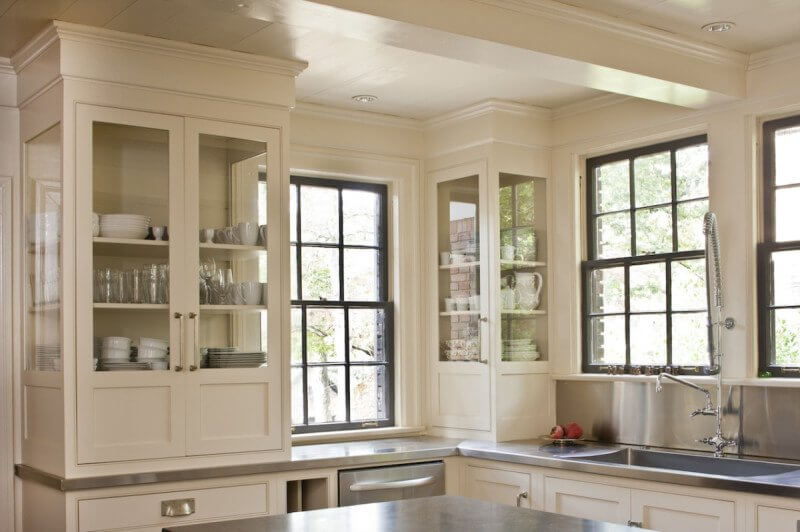 Glass cabinetry maximizes the light from the windows.