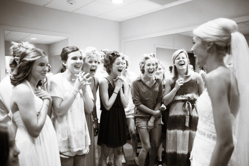 Taylor’s bridesmaids squeal with excitement upon seeing her for the first time in the dress!