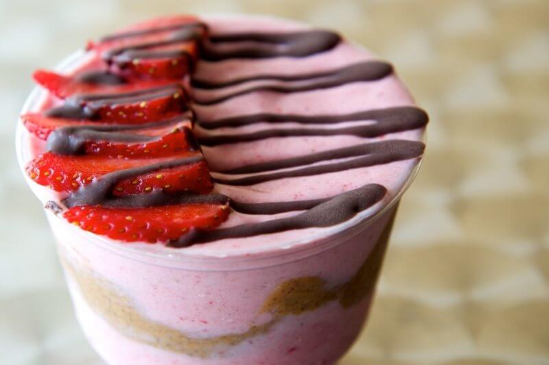 Strawberry Banana Protein “Ice Cream”: Strawberries, bananas, cashew almond milk, organic grassfed whey protein, hemp seeds; layered with almond butter, healthy “magic shell” and strawberry slices. Juice Revolution