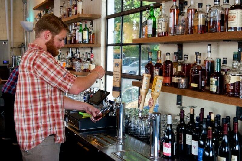 Pouring a beer at Adele's