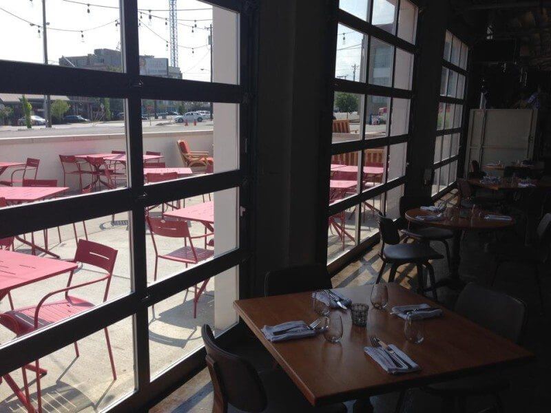 The clear glass frames a view of the main patio; doors roll up in good weather.