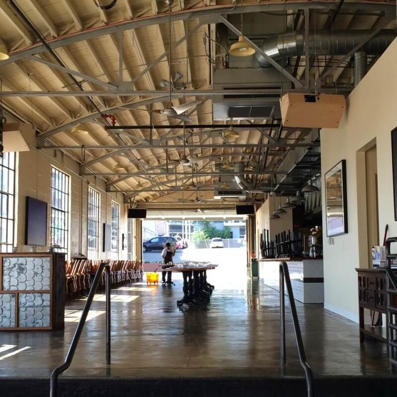 Polished concrete floors in main dining room get mopped to a clean sheen. Look at the beautiful original bowstring trussed ceiling
