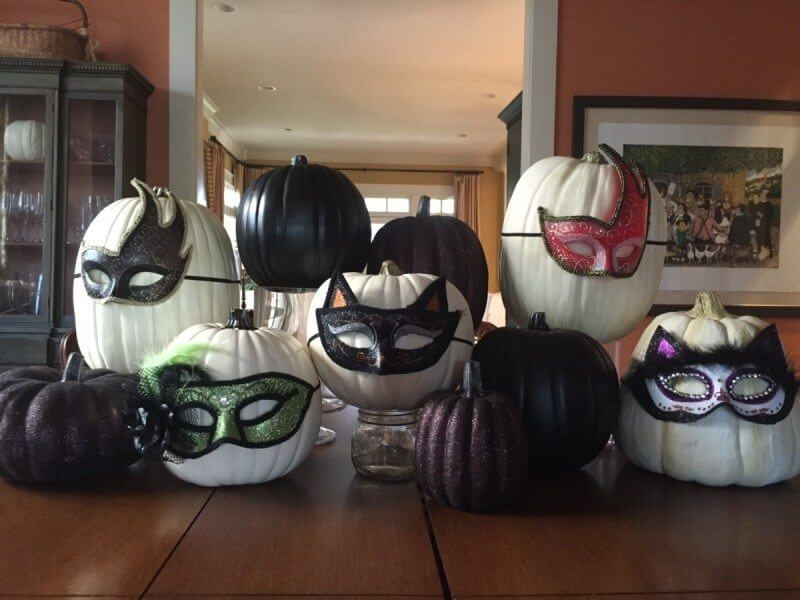 Halloween masks on pumpkins
