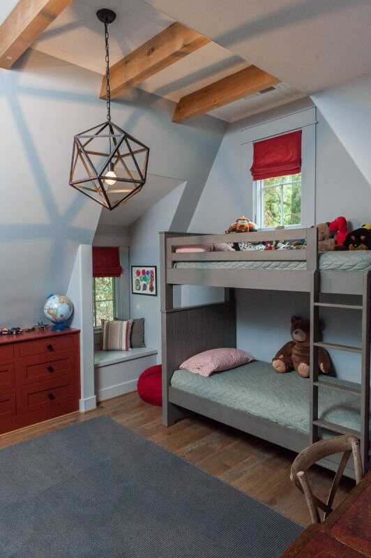 Both boys room are furnished in a similar fashion with the same paint colors and trim, giving continuity to the home. Christopher Architecture and Interiors
