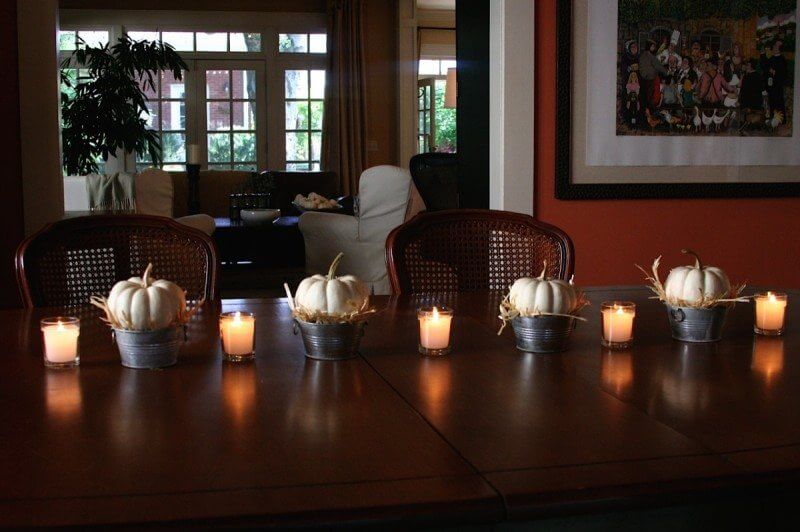 white baby pumpkins with straw