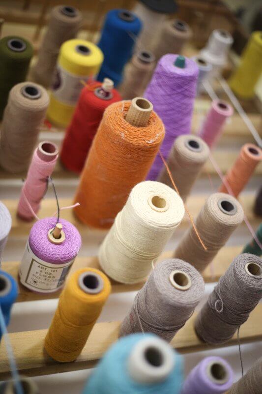 Colorful spools await a new life woven through re:loom products. 