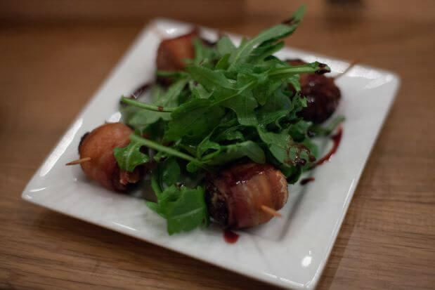 Bacon wrapped dates with stilton cheese and port drizzle.