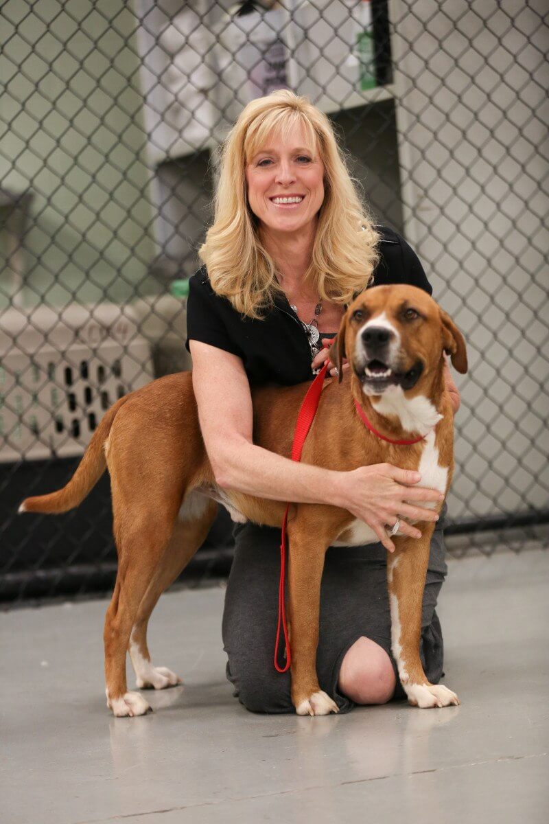 Charlie Brown shows his appreciation for Susan Jacobs-Meadow, founder of Canine Cellmates.