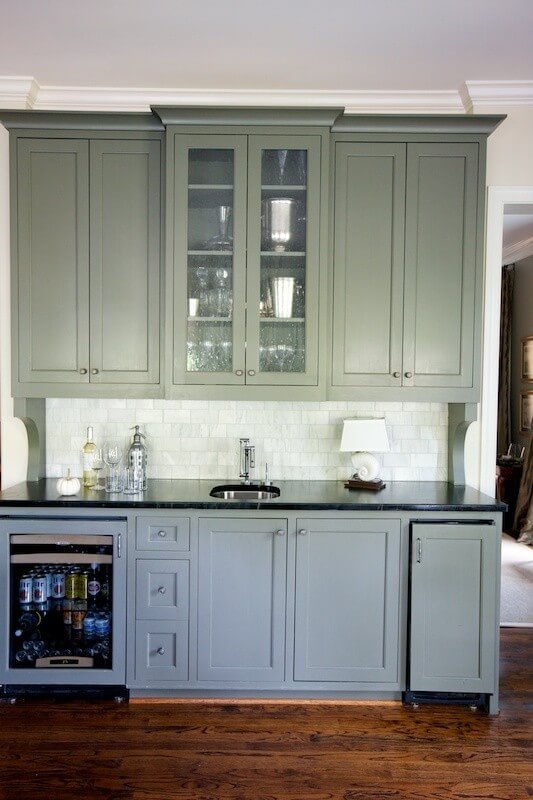 A bar area provides additional cabinet storage plus a mini fridge.