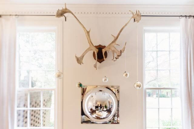 This retro mirror adds such a fun element to the room. Add the moose antlers (decorated with silver ornaments) and you have a neutral display with high impact.