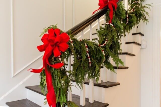 Fresh greenery, red bows and felted garland make for nostalgic Christmas decor.