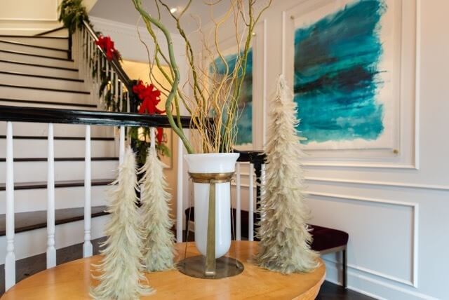 Just inside the front door, you are greeted by modern art in bright colors. Notice all the moldings, which were added as part of the renovation of this vintage, modern home.