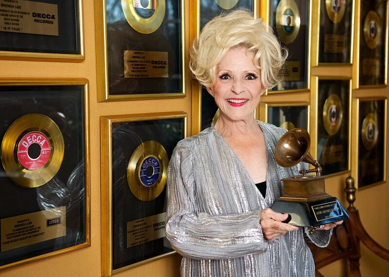 Brenda Lee in front of her impressive collection of achievements in her Nashville home