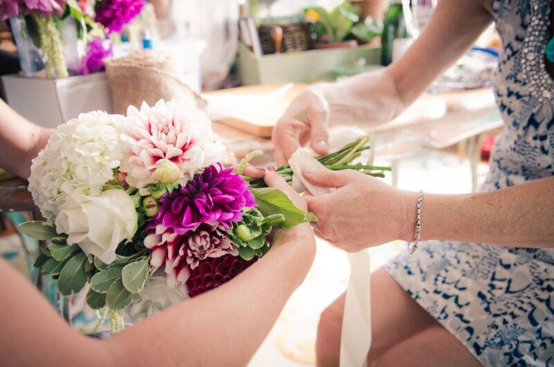 Hundreds of wedding flowers were gifted from the personal gardens of friends in the area, some hand-tied into bouquets for the bride and her bridesmaids.