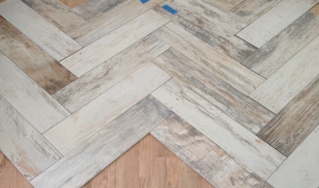 Emulating well-worn floors that one might find in an old French farmhouse or a Parisian apartment, these porcelain tiles provide depth and texture to the master bath.