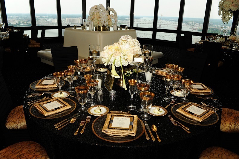 Hometown NBA Star marries in Louisville in a lavish wedding. The colors of the wedding were black and gold, reflected here at the guest's tables. Note the incredible view from the top of the Galt House at Rivue.