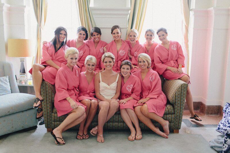 The Best of Louisville wedding-bridesmaids in their pink matching robes help the bride get ready.