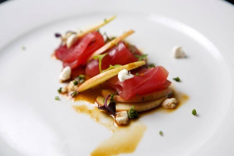 Maguro Ringo is topped with Stone Hollow Farmstead goat cheese. | Image via Jinsei