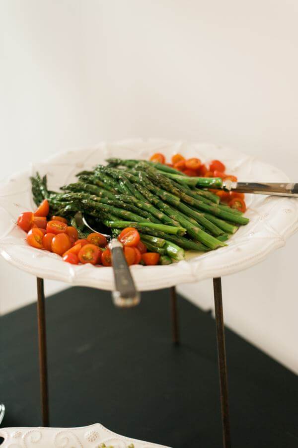 Roasted Asparagus served with a zesty lemon-dijon dressing and halved grape tomatoes. A make ahead recipe.