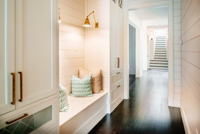 The cozy hallway wouldn't be complete without the built-in bench with overhead lighting. 
