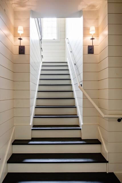 Wood paneling adds rustic charm to this beautiful staircase. 