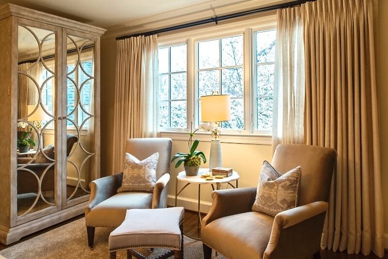 The seating area in the master bedroom takes advantage of natural light.