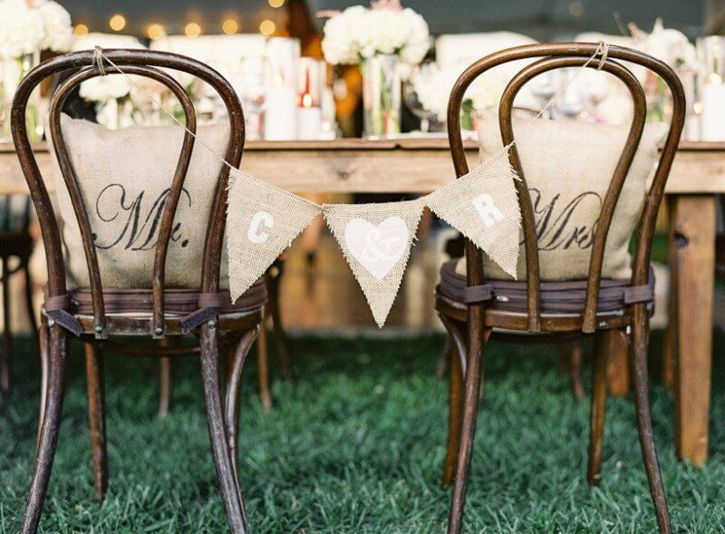 The bride/groom chairs were personalized with a banner and pillows
