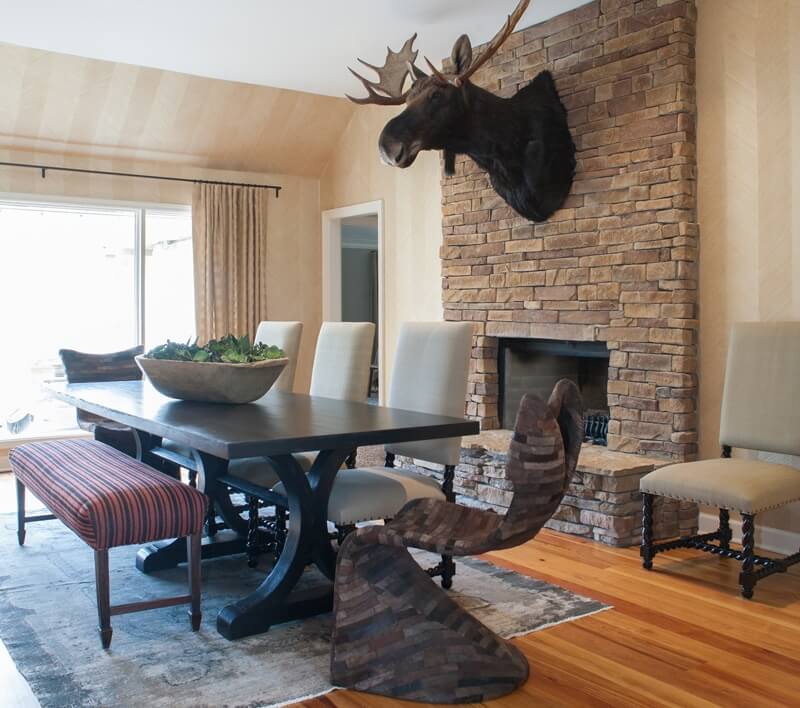 “In our very first meeting,” Selena recalls, “he (the homeowner) showed me a buffalo head in his office that was at least five feet tall and a picture of a moose head taller than me and said, ‘We are going to need to find a home for this.’" Note the different seating options at the table.| Image credit: Julie Wage Ross