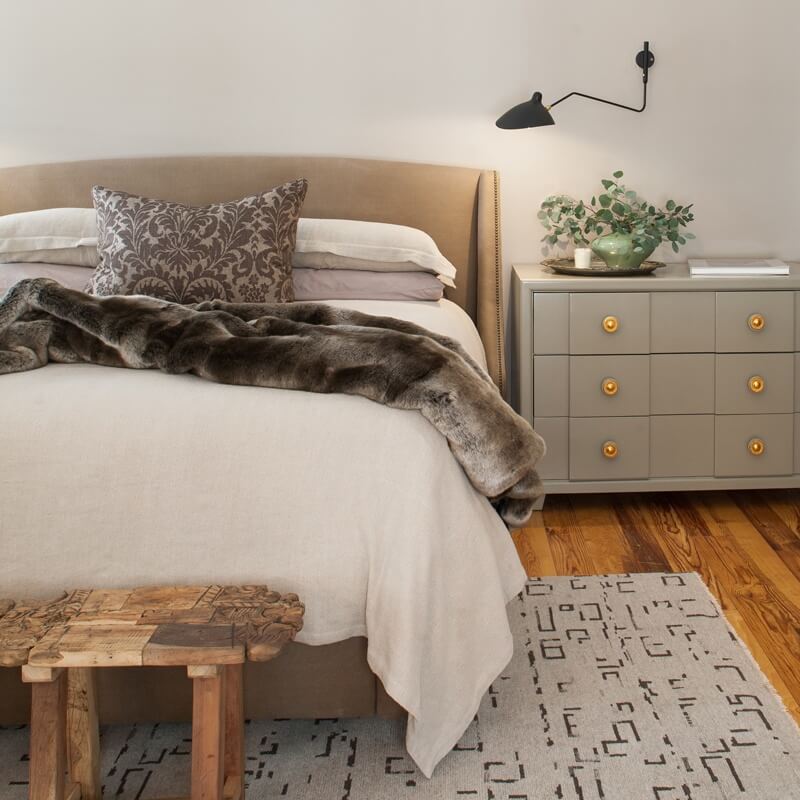 Modern furnishings in the master bedroom include an area rug from Kiser's Floor Fashions. | Image credit: Julie Wage Ross