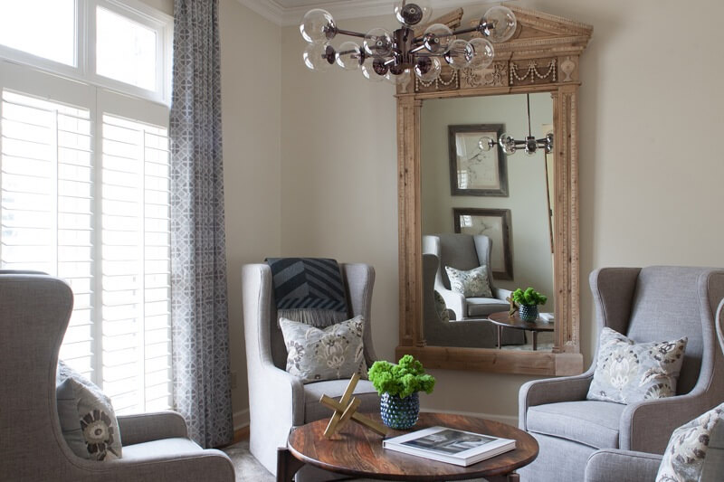 in the sitting room, a large, ornate mirror already present in the home was inspiration for the scale and style of other furnishings in the sitting room. | Image credit: Julie Wage Ross