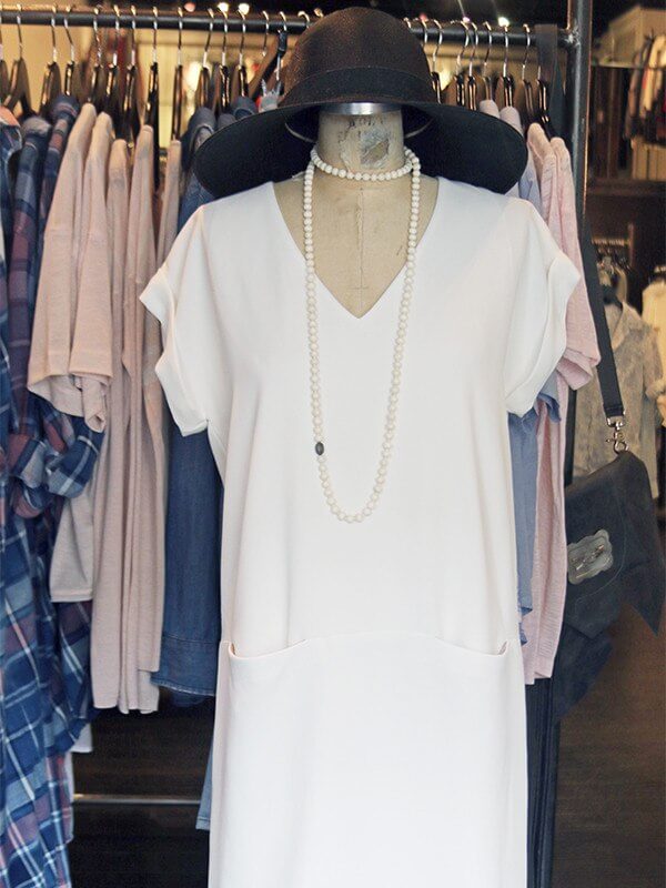 A wide brim hat and layered necklace give this simple white dress an extra flair!