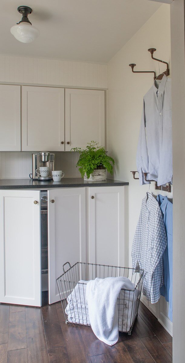 By using the same cabinets and counter tops in the kitchen and laundry room and hiding the washer and dryer behind lower laundry cabinets, the laundry room became an extension of the kitchen. 