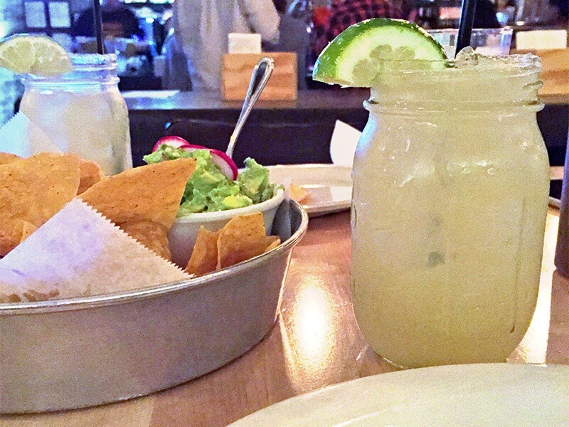 Chips and guac and a margarita in a mason jar at Bakersfield