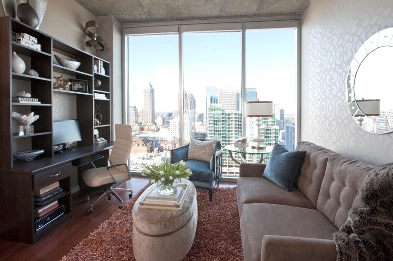 This efficient room functions as both home office and guest bedroom, thanks to a hard-working desk unit and sofa that sleeps two. A movable storage ottoman is on wheels for easy access.