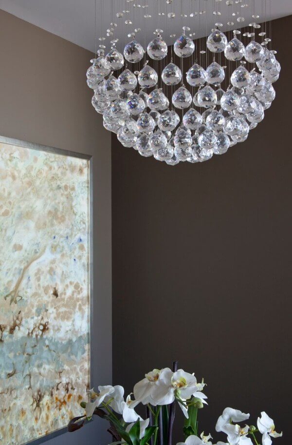 An artsy chandelier illuminates an abstract painting by artist Blakey Berring, who is out of Texas.