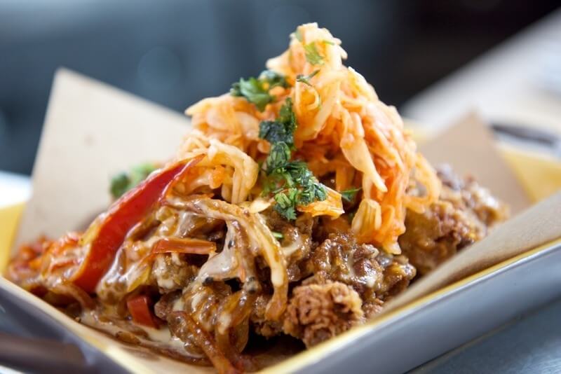 The fried chicken liver features white barbecue sauce and onion sticks.