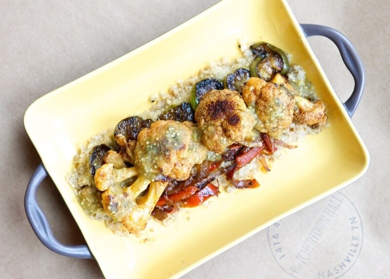 Chef Hrant's spin on paella features big florets of cauliflower, peppers and other roasted seasonal vegetables on a bed of quinoa soaked in tomatillo broth.