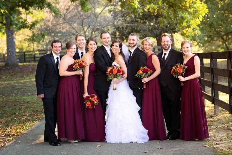 The entire bridal party looking very dapper and chic in hues complimentary of the season's colors behind them.