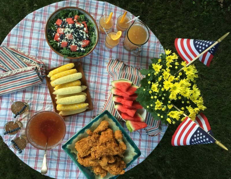 Summer July 4th Easy Table deco: See how pretty this table is? The flower is on a wine box with a napkin on top of it. The chicken is placed atop a pot made for a plant. Height makes the table more interesting.