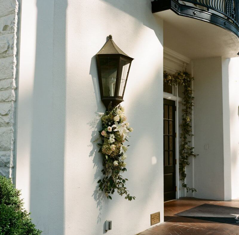 The leafy and less manicured arrangement looks lovely against the crisp white walls of the Mountain Brook Club.