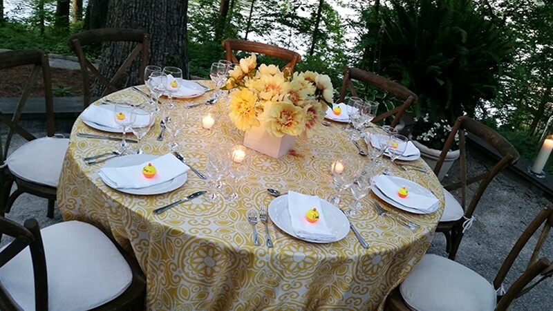 Campbell placed clusters of yellow peonies in the center of each table, and added whimsical name cards made with small fishing buoys. 