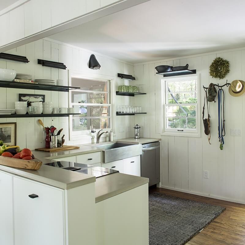 For the small but efficient kitchen, David Doss created floating shelves with glass inserts, and Old City Millwork built the custom cabinetry.