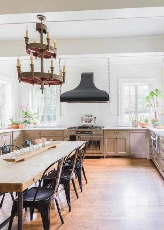 The chandelier is from an old church and the table was modeled after one found at Star Provisions in Atlanta. With windows on three sides, the natural light is beautiful. ©AlyssaRosenheck2015-1