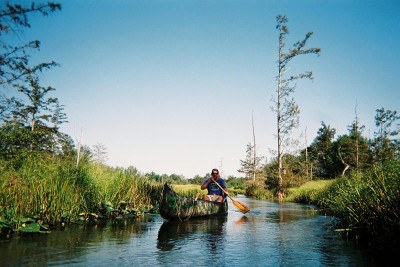 man canoeing on a river