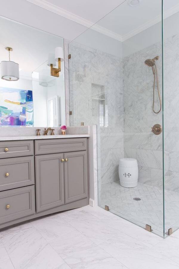 New vanity overall: A semi-custom new vanity and creative use of tile gives this bath a fresh look. Porcelain tiles on the floor and throughout the shower are a durable alternative to marble, at a lower price point.