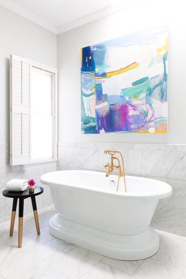 Tub area: The designer put as much thought into lighting and art in the bathroom as she would for a living room. “Bathrooms are not just utilitarian rooms in a home, so furnish them as you would your sitting room with a bench, art work, things like that,” Braund says. “It can be a room of respite that you stay in for a while, not just a room that serves an end use.”