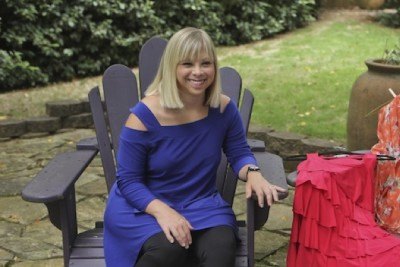Ashley DeRamus happily displays her fashion lines—Ashley by Design, which includes some clothes designed specifically for women with Down syndrome, as well as Adore Kids for children and babies.