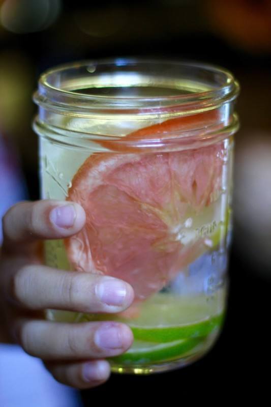 Fruit water: Here you can see we pushed the floating limes down with a big slice of frozen a grapefruit wheel and lemons. Doesn't that look fabulous? Keep these bagged in your freezer and delight your family or any guests you have over. See how simple these are to make here.